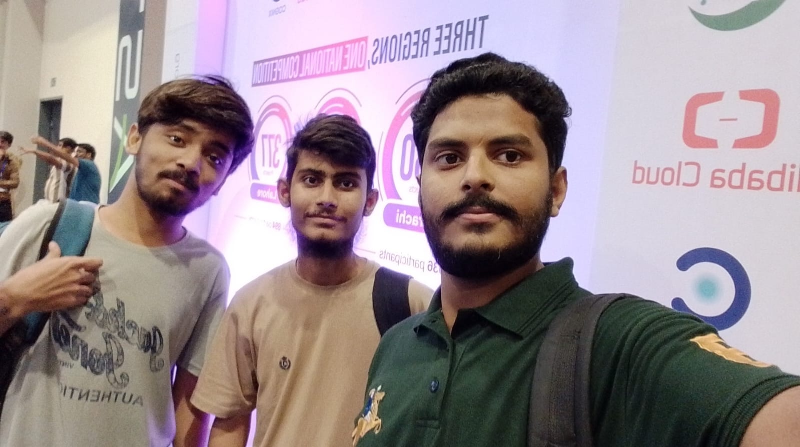 The three AgentraX founders at the Alibaba Cloud AI Hackathon in Karachi